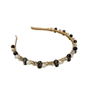 Vintage gold headband with pearls, black beads and crystals on a white background