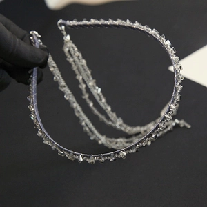 Detail of beaded headband featuring dark grey crystal tassels and velvet material