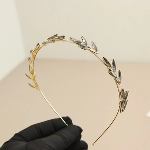 Vintage gold leaf headband with smoky grey crystal accents for elegant bridal hairstyling