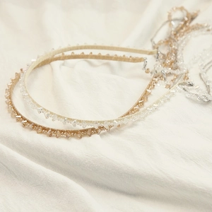 Close-up of handmade beaded headbands with amber crystals and silver adjustment chains