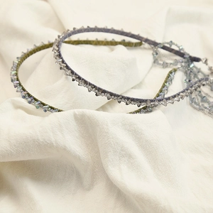 Detailed shot of handmade beaded headband with gradient crystal fringes and metal chain end