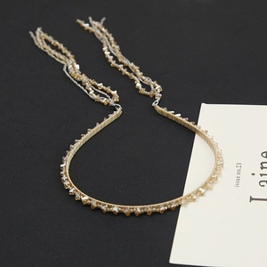 Detail of champagne crystal beaded headband featuring elegant multi-layer fringe tassels