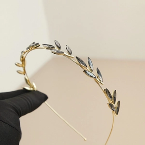 Detailed view of vintage gold leaf headband featuring marquise grey rhinestones