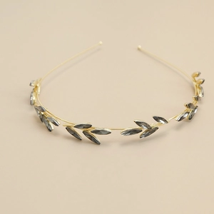 Detail of vintage gold leaf headband with grey crystal embellishments in Greek style