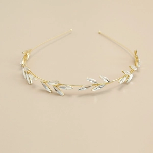 Close-up of golden rhinestone headband with marquise crystal leaf designs for wedding