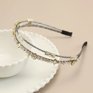 Detailed macro view of double-layer headband with clear crystals and golden alloy base
