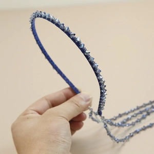 Detail of royal blue beaded headband featuring crystal fringe and soft velvet texture