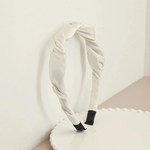 Elegant ivory satin headband with twisted design and delicate pearl accents for women