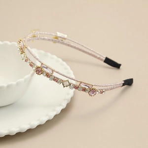 Detailed view of pink double-row headband with sparkling crystals and various rhinestones