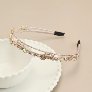 Close-up of pink and white crystal double-layer headband on a white ceramic bowl
