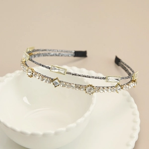Detail of elegant double-layered headband with sparkling rhinestones and woven texture