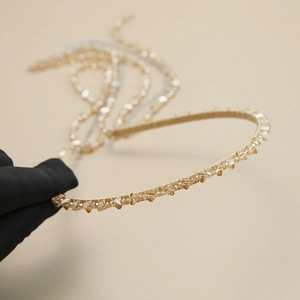 Close-up of golden beaded headband with gradient amber crystals and sparkling sequins