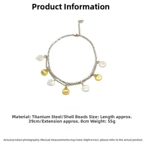 Close-up of double-layer titanium necklace featuring round white pearls and gold letter charms