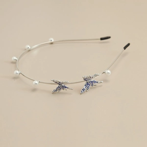 Detail of silver metal headband featuring gradient butterflies and small white pearls