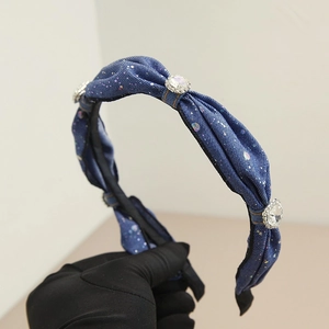 Detail of denim headband with sparkling rhinestones and large crystal embellishments