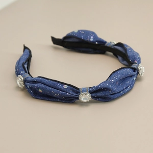 Detail of denim fabric headband with sparkling glitter and large rhinestone embellishments