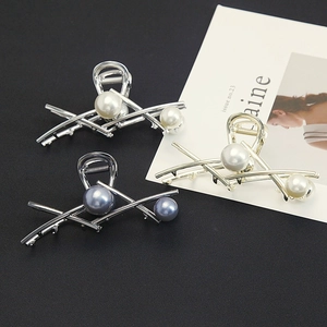 Detail of minimalist metal shark hair clips with pearls and strong metal spring structure