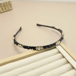 Serre-tête élégant en cristaux noirs et strass scintillants sur plateau à bijoux