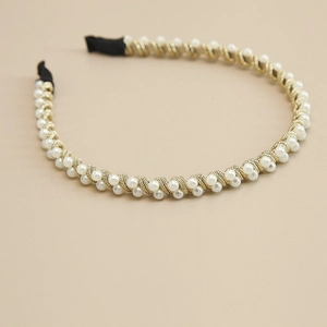 Detail of handcrafted gold wire headband with dense white pearl bead embellishments