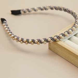 Detail shot of elegant woven pearl headband with champagne beads and silver grey threads