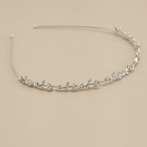 Elegant silver floral headband with rhinestone vine design for bridal or festive hair styling
