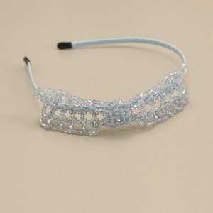 Detailed view of hand-woven light blue crystal beads on a slim elegant headband