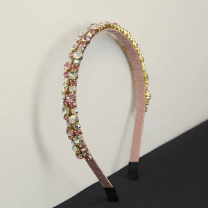 Detail view of the pink rhinestone headbands with crystal accents and satin lining texture