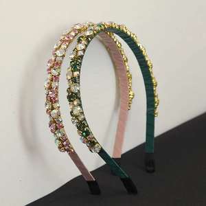 Close-up of vintage rhinestone headbands with intricate hand-set crystals and fabric wrap
