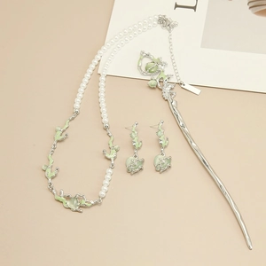 Detailed set of silver floral necklace, opal earrings and hairpin on beige background