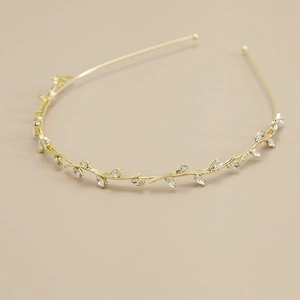 Detail of elegant gold vine headband with shimmering marquise and round rhinestones