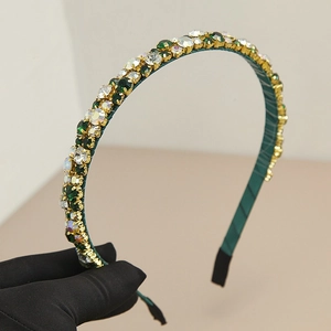 Elegant emerald green rhinestone headband with gold finish for vintage luxury hair styling