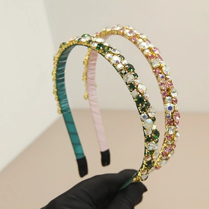 Detail of luxury rhinestone headband with gauze wrapping in green and champagne colors