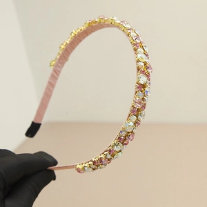 Detailed close-up of pink headband with shimmering colorful rhinestones and crystals