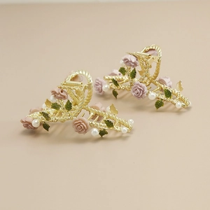 Detail of rose vine hair claw with pink resin flowers, white pearls and golden alloy