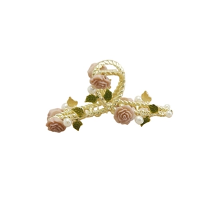 Elegant gold vine hair claw clip with pink roses, green leaves, and white pearls detail
