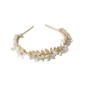 Serre-tête doré avec fleurs blanches mates, perles et strass sur un fond blanc pur