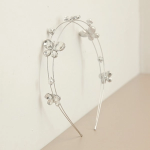 Silver double-layer headband with crystal butterflies and pearls on a light background