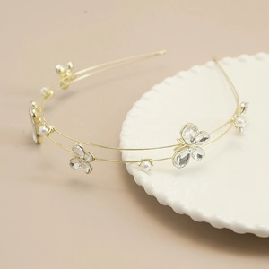 Detail shot of the double-layer gold headband with crystal butterflies and pearls