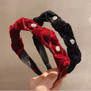 Close-up of velvet braided headbands with sparkling rhinestones in red and black colors