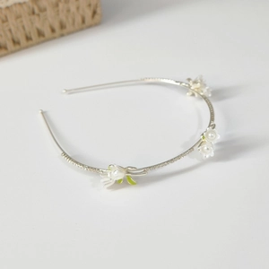 Elegant silver thin headband with white lily of the valley flowers and green leaves