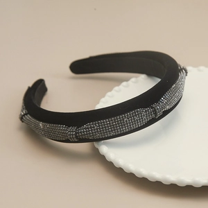 Detail of black velvet padded headband featuring shimmering gray rhinestones for hair