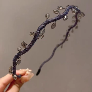 Detail of blue fabric wave headband with sparkling beads and black protective tips