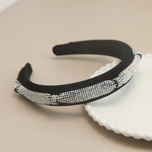 Detail of luxury velvet headband with sparkling rhinestones in a wave pattern