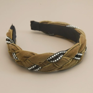 Detail of woven velvet headband featuring white pearls and golden metallic thread accents