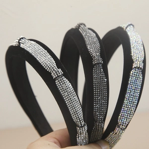 Detailed view of three black velvet headbands with sparkling silver rhinestones