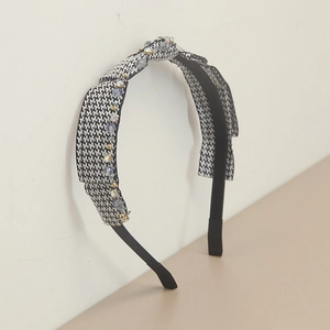 Detail of handmade houndstooth headband with light blue crystal bead embellishments