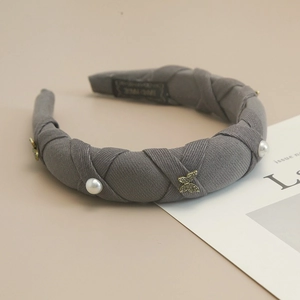 Detail showing grey ribbed fabric headband with pearls and gold butterfly charms
