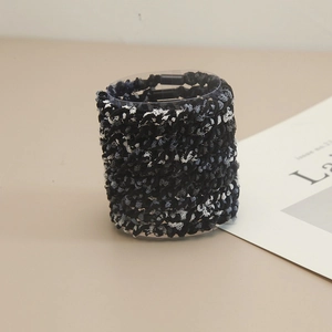Knitted elastic hair ties set in black, white and blue grey displayed on a stand