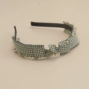 Detail view of French retro headband with black and white plaid fabric and crystal beads