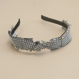 Detailed close-up of houndstress fabric with embedded crystals on a French retro headband